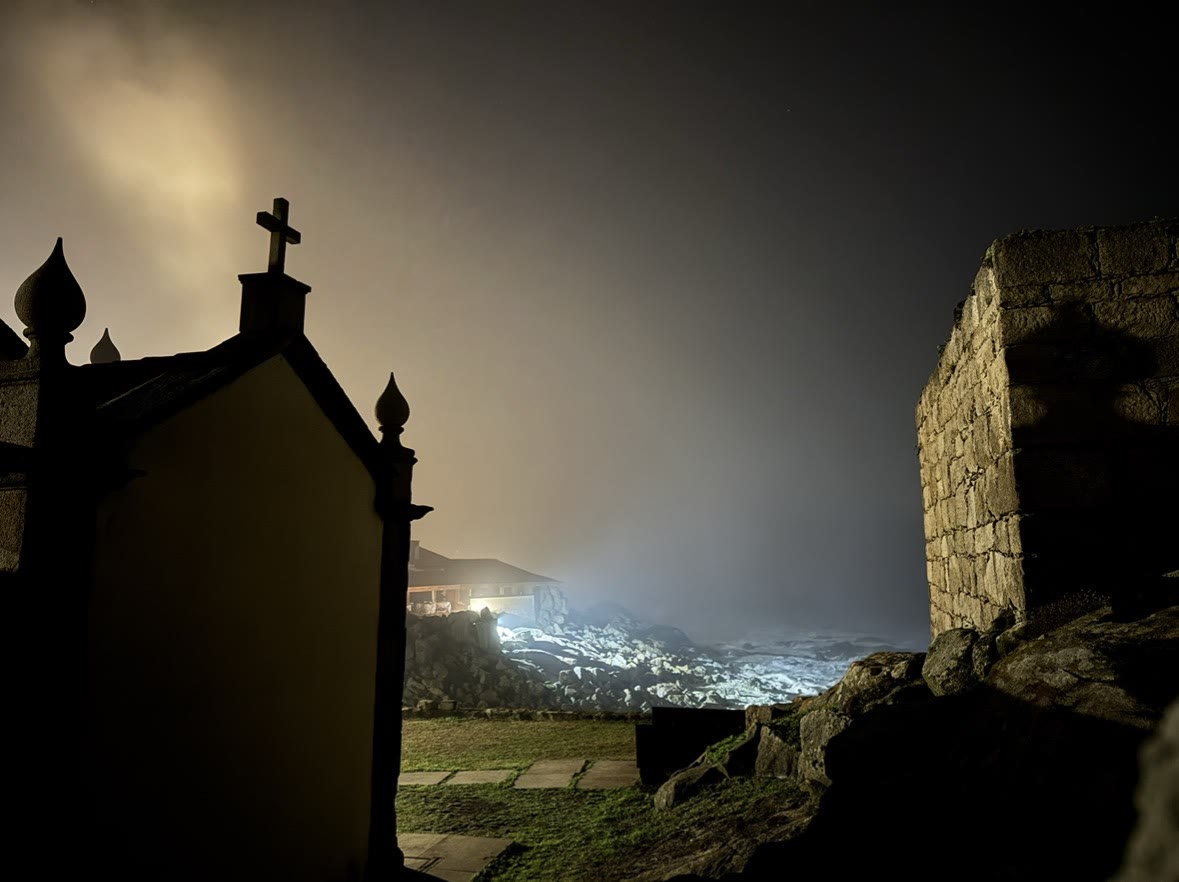 Stone building at night beside the sea